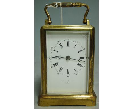 An early 20th century lacquered brass cased carriage clock, having a white enamel dial with Roman and Arabic numerals, indist