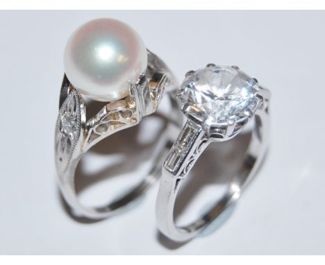 An art deco style platinum gem set dress ring together with a white metal synthetic pearl set dress ring, gross weight 9.8g (