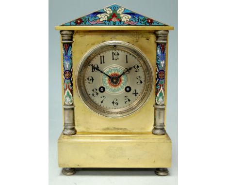 A late 19th century brass cased and enamelled mantel clock having a silvered dial with arabic numerals and 8-day movement Con