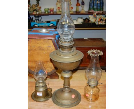 An early 20th century turned brass oil lamp together with two others (3)
