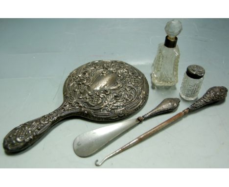 A small collection of miscellaneous silver items to include silver backed hand mirror, button hook, and dressing table jars