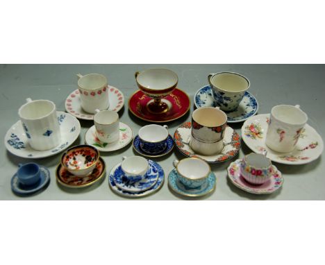 A collection of miniature teacups and coffee cans to include; Coalport Willow pattern, Royal Worcester Blue Sprays etc 