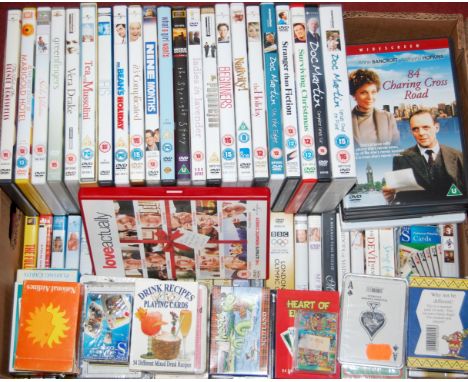 A box of assorted DVDs and playing cards etc 