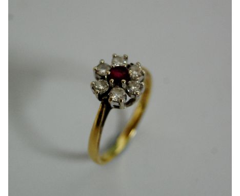 A modern ladies 18ct gold ruby and white sapphire cluster ring