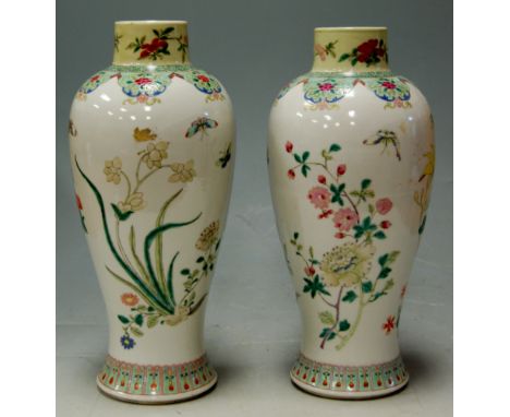 A pair of early 20th century Chinese stoneware vases of baluster form enamel decorated with flowers and butterflies, h.29cm C