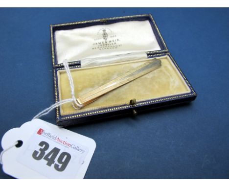 A 9ct Gold Gent's Tie Slide, engine turned, in a fitted case. 