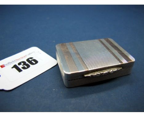 A Hallmarked Silver Pill Box, PJD, Birmingham 1996, allover engine turned with stripe highlights and textured thumbpiece, gil