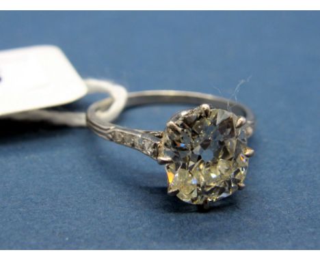 A Large Single Stone Diamond Ring, the (9mm at widest point) old cushion cut diamond eight claw set, between rose cut diamond