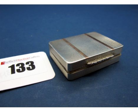 A Hallmarked Silver Pill Box, PJD, Birmingham 1992, allover engine turned with stripe highlights and textured thumbpiece, gil