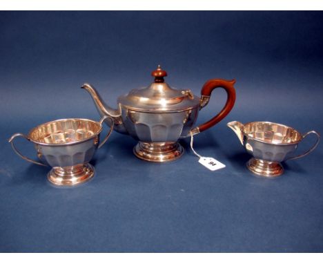 A Hallmarked Silver Three Piece Teaset, L&R, Birmingham 1932, each of panelled form, on circular spreading base, total weight