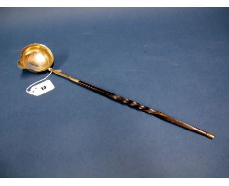 A Georgian Toddy Ladle, the bowl with side spout and twisted handle, 39cms long.