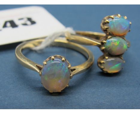 A Three Stone Opal Ring, of uniform design, line set; Together with A Single Stone Opal Ring, claw set. 