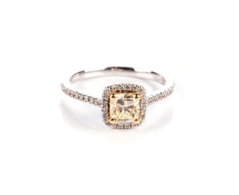 A DIAMOND RING Claw-set to the centre with a fancy radiant-cut yellow coloured diamond, weighing approximately 0,68ct, approx