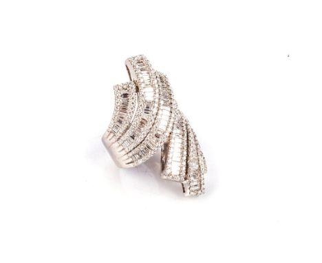 A DIAMOND DRESS RING Of crossover design, with three tapered bands each with centred with a row of baguette-cut diamonds weig