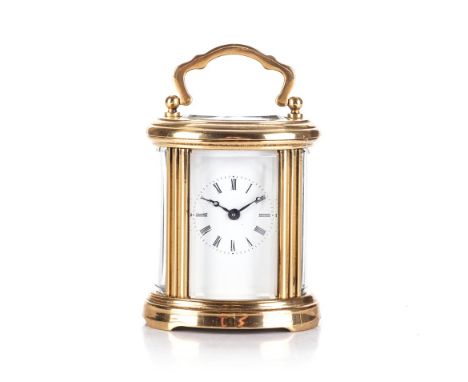 A BRASS CARRIAGE CLOCK The rectangular white dial with Roman numeral hour markers, calibrated outer ring, oval five bevelled 