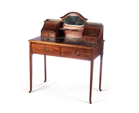 AN EDWARDIAN BUREAU-DE-DAME The moulded rectangular top with a gilt-tooled leather inset writing surface surmounted by a gall