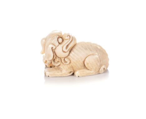 A JAPANESE IVORY NETSUKE OF A RECUMBENT SHI-SHI, TAISHŌ PERIOD, 1912 – 1926 NOT SUITABLE FOR EXPORTThe recumbent animal with 