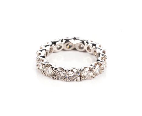 A DIAMOND ETERNITY RING Claw-set with sixteen round brilliant-cut diamonds weighing approximately 3,50ct in total, approximat