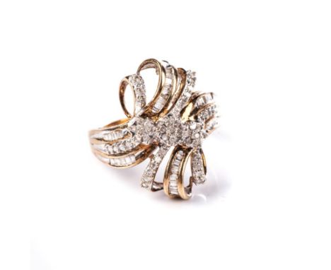 A DIAMOND DRESS RING Of cross-over ribbon design, centred with three flower head cluster motifs, embellished with single- and