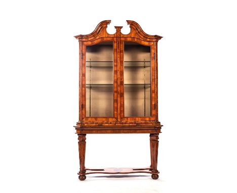 A DUTCH WALNUT DISPLAY CABINET, 19TH CENTURY The moulded broken pediment above a pair of glazed doors enclosing two shelves, 