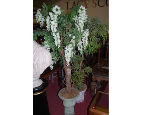 A classical pedestal planter; together with a white ceramic example, both with foliage (2)