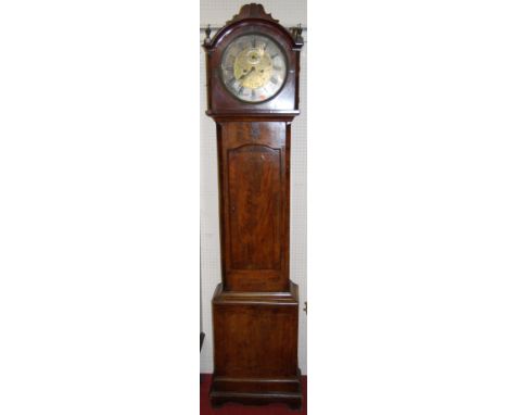 A 19th century mahogany longcase clock, having a circular silvered and brass dial, with twin winding holes for an eight day w