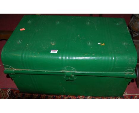 An early 20th century green painted metal hinged top travelling trunk