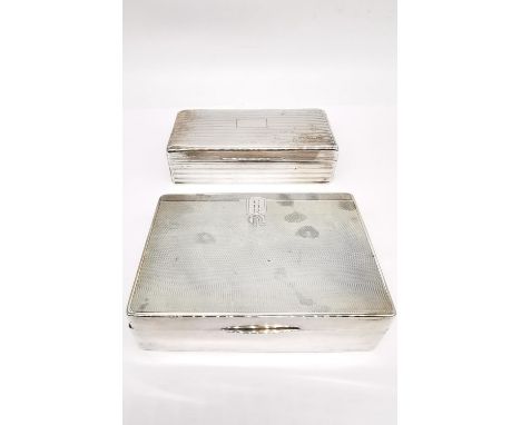 Two silver cedar lined cigarette boxes, one by William Neale with engraved monogram and geometric design and the other with a