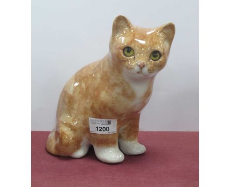 A Winstanley seated ginger tabby cat with yellow glass eyes, signed to base, approx 19cm high.