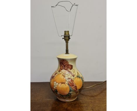 A Moorcroft Berry and Bird pattern on beige background lamp base, stamped to base, height of base approx. 26cm. IMPORTANT: On