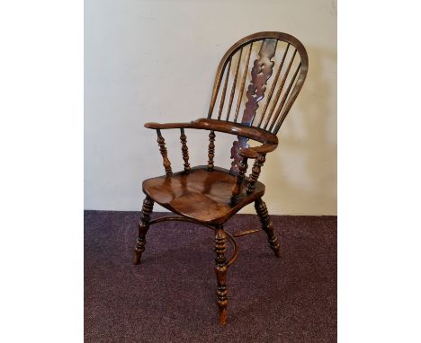 A 19th century Ash and Elm Windsor chair with yew wood central panel and stick back, on turned legs with bow stretcher, 113cm