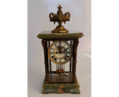 An Ansonia New York clock with onyx base and top, brass fittings to four glass panels and and brass Grecian finial to top, he