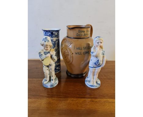 A Doulton Lambeth salt glazed jug depicting Benjamin Disraeli Earl of Beaconsfield, together with two figurines, girl and boy