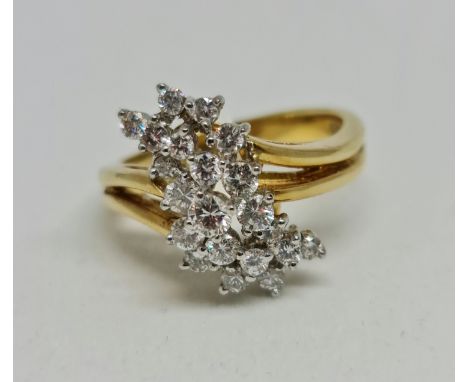 A hallmarked 18ct yellow gold diamond cluster ring, set with 21 variously sized round brilliant cut diamonds, total diamond w