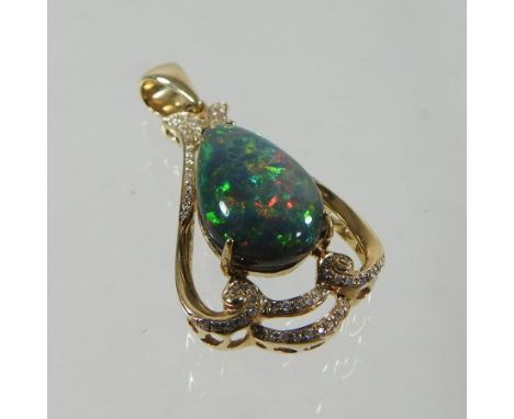 A 14 carat gold diamond and opal pendant