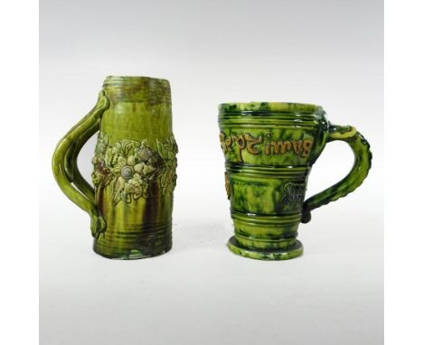 A Castle Hedingham green glazed pottery mug, with an applied floral frieze, 17cm high, together with a Castle Hedingham green