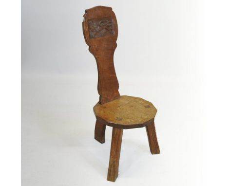 A mid 20th century carved light oak spinner's chair, by Thomas 'Gnomeman' Whittaker