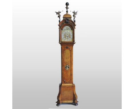 An early 18th century Dutch figured walnut longcase clock, circa 1720, the hood with fret carved decoration, surmounted by th