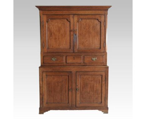 An 18th century Welsh oak cupboard, with a moulded cornice, enclosed by panelled doors, on bracket feet, 126cm