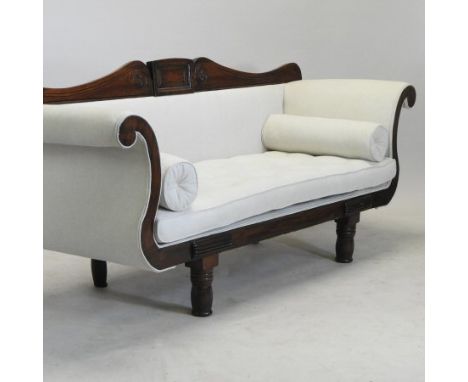 A late Regency mahogany and grey upholstered scroll end sofa, having a carved back, on turned legs, 196cm