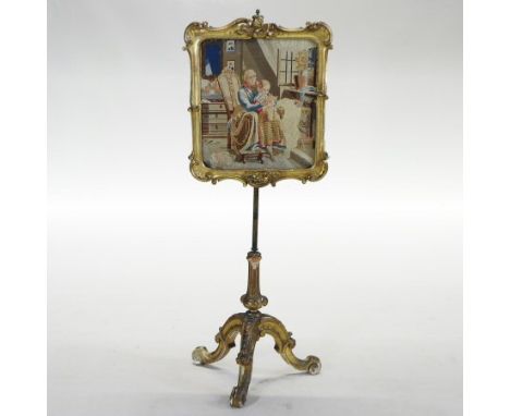 A Victorian gilt painted fire screen, inset with a tapestry, on an adjustable tripod stand, 142cm high