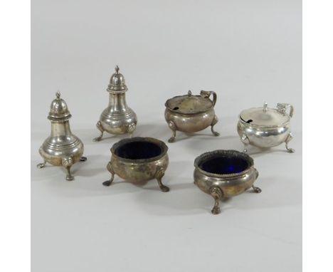 A silver Garrards six piece condiment set, comprising a pair of mustards, a pair of open salts with blue glass liners and a p