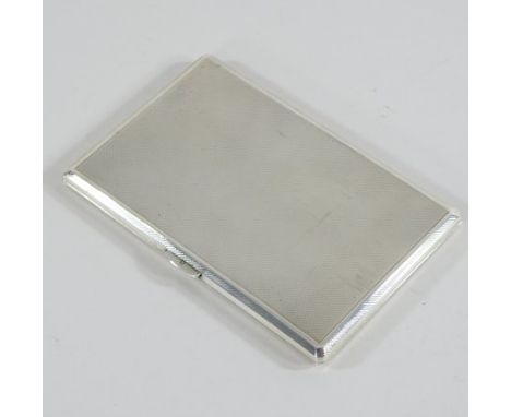 An early 20th century silver cigarette case, with engine turned decoration, by Carrington & Co, London 1954, 13cm