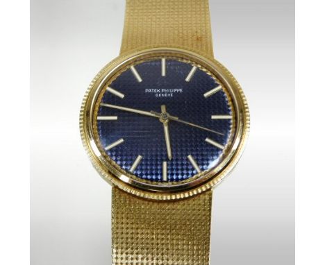 A Patek Philippe vintage 18 carat gold cased gentleman's manual wind wristwatch, circa 1960's, the signed textured blue dial 