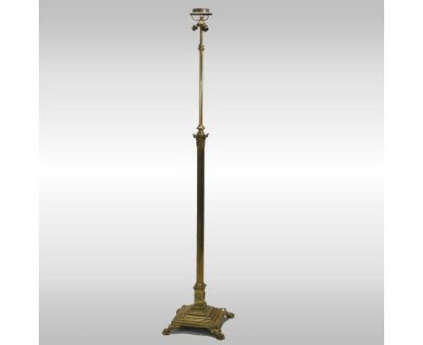 An early 20th century brass telescopic standard lamp, in the form of a Corinthian column,  on paw feet, 193cm high fully exte