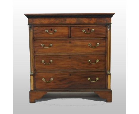 A George III mahogany chest, containing two short over three long drawers, flanked by Corinthian columns, with brass capitals