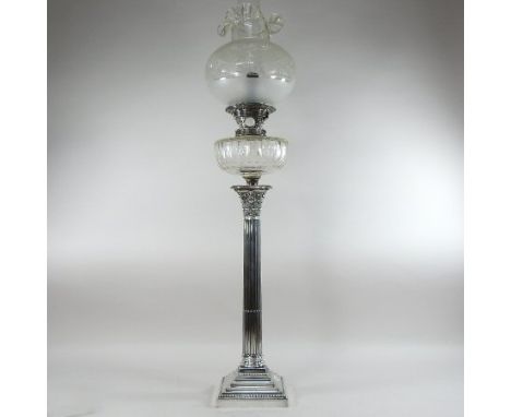 A 19th century silver plated oil lamp, in the form of a Corinthian column, with an etched clear glass shade, 89cm high overal