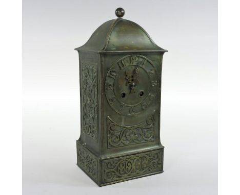 An Arts and Crafts brass cased mantel clock, with fret carved decoration, the brass movement striking on a bell, numbered 397