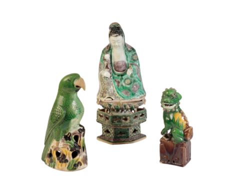 FAMILLE VERTE FIGURE OF GUANYIN, KANGXI PERIOD, the seated figure with a child resting on her knee, raised on a lotus throne,