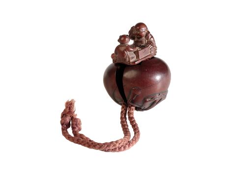 JAPANESE CARVED WOOD NETSUKE, TOKYO SCHOOL, MEIJI PERIOD, modelled as Hotei's sack, which opens to reveal Hotei and karake pl